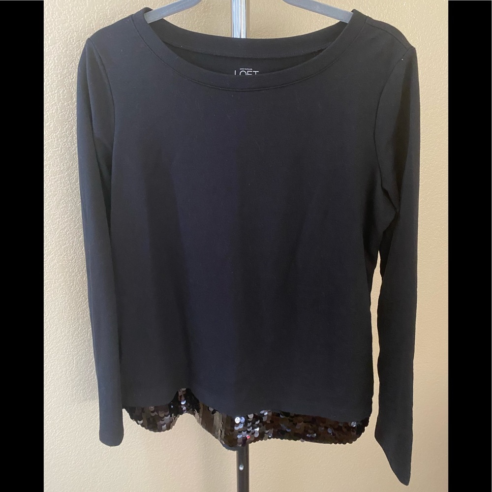 NWOT black top with sequence at the bottom.